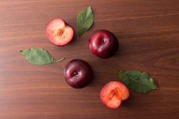 Plums on wooden background