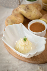 Mashed potatoes in a plate on a wooden table
