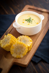 Corn soup in bowl and sweet corn on plate