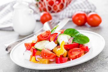 Tomato salad with fresh bell pepper, red onion and feta cheese. Healthy eating