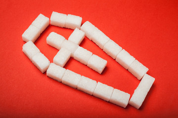 Sugar kills, a coffin made of cubes of sugar on a red background.