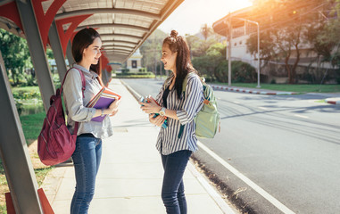 A group of teenage student in university smiling and reading the book in summer holiday.