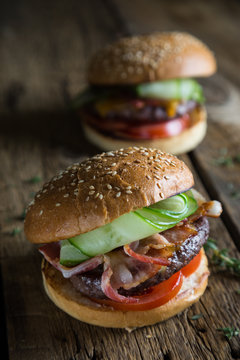 Big burger with bacon and fresh cucumber