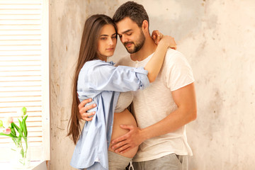 couple in love pregnant cuddling, waiting for baby © Rock and Wasp