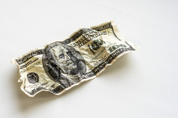 Crumpled hundred dollars on a white background
