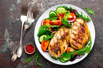 Grilled chicken breast. Fried chicken fillet and fresh vegetable salad of tomatoes, cucumbers and arugula leaves. Chicken meat with salad. Healthy food © Sea Wave
