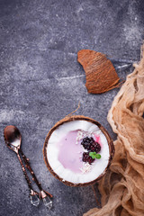 Blackberries smoothie in coconut shell