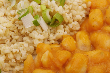 Pumpkin sauce and beans with bulgur on a table