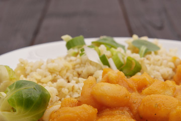 Pumpkin sauce and beans with bulgur on a table