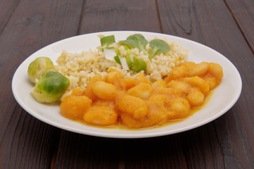 Pumpkin sauce and beans with bulgur on a table