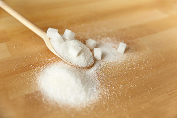 Close Up Of White Sugar In Spoon On Table.