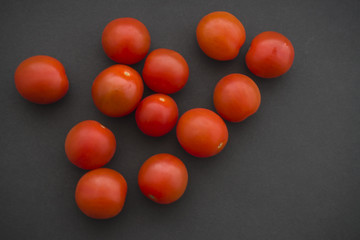 cherry tomatoes on a black background