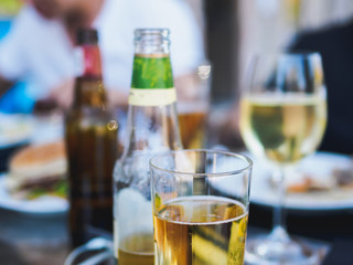 Apple cider in the glass and bottles in cafe