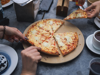 Lifestyle pizza party of friends. grey table