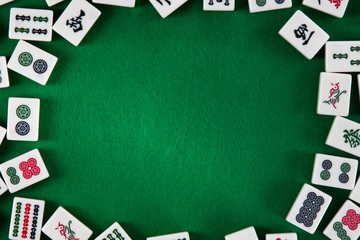 White-green tiles for mahjong on on green cloth background - obrazy, fototapety, plakaty