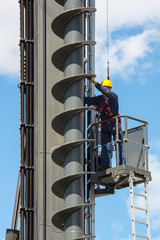 The worker on the machine for drilling holes in the ground