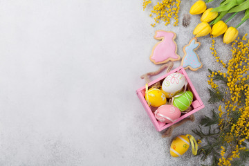 Easter eggs and yellow flowers. Greeting card