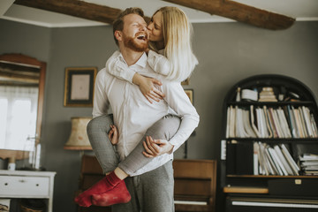 Loving couple kissing in the room