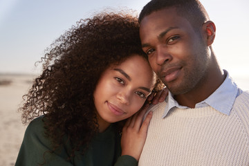 Portrait Of Couple On Walking Along Winter Beach Together