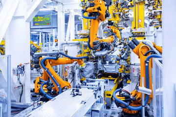 robotic arms in a car plant