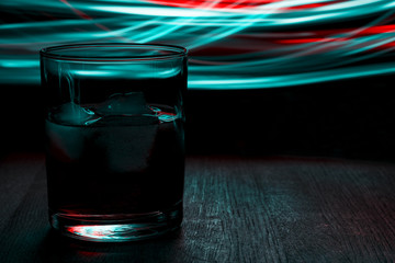Glass of whiskey on the table. Bokeh effect.