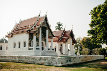 Wat Uposatharam Temple or Wat Bot at noon under clear blue sky, Thailand