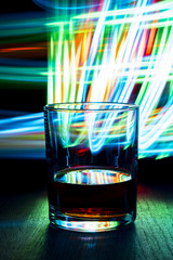 Night club. A glass of cognac on the table.