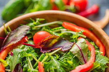 Fresh rustic vegetable salad on rustic background