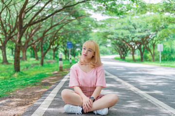 Obraz premium Portrait of beautiful asian girl golden hair with camera,Thailand people in pink dress,hipster girl