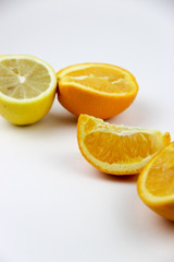 Cut orange and lemon on a white background.