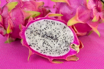 Open Dragon fruit in pink colourful background