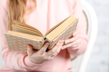 Female reading book, close up