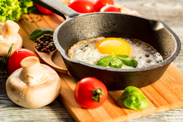 Fried eggs in a frying pan. Rustic breakfast