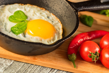 Fried eggs in a frying pan. Rustic breakfast