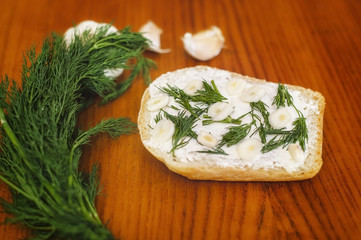White bread sandwich with chopped garlic and green dill