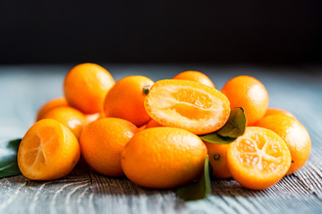 Kumquat or cumquat on wooden table
