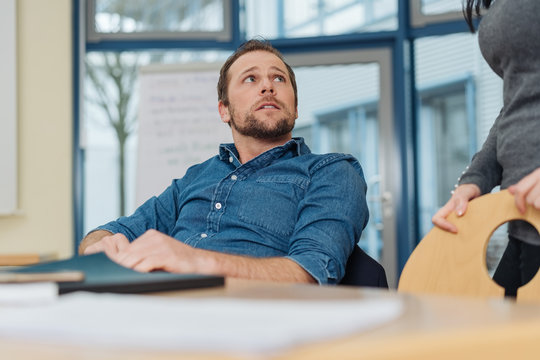 Businessman looking up listening to a colleague