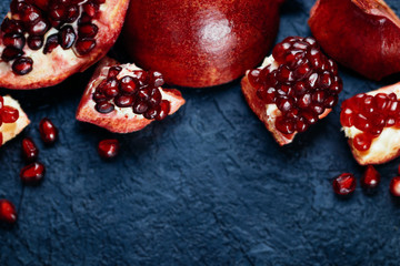 Fresh ripe pomegranate on a slate plate kitchen table