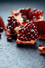Fresh ripe pomegranate on a slate plate kitchen table