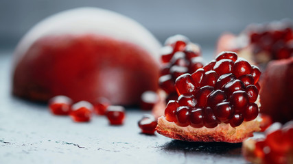 Fresh ripe pomegranate on a slate plate kitchen table