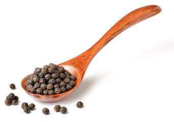 dried black peppercorns in the wooden spoon, isolated on white