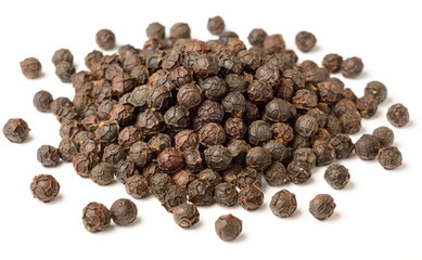 close up of dried black peppercorns isolated on white