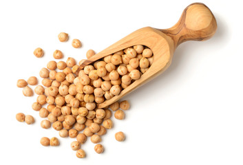dried chickpeas in the olive wood scoop, isolated on white, top view
