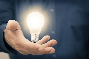 hand holding the light bulb on, concept of idea and creativity