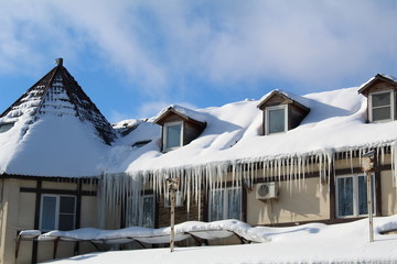 A lot of icicles on the roof of the building. © Elena Bondareva