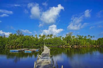 Old broken abandoned fisherman jetty / pier made from wood.