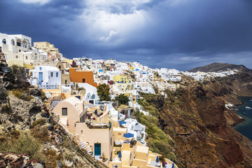 Fototapeta na wymiar View of the city of Oia on the island of Santorini and the waters of the Aegean Sea in Greece
