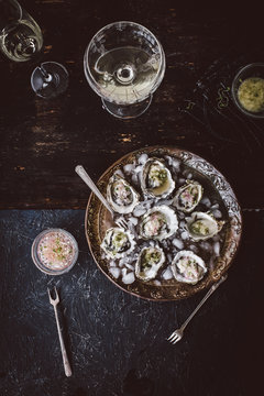 Oysters with serrano cilantro mignonette sauce and glass of wine