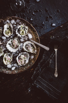 Fresh oysters with serrano cilantro mignonette sauce on plate