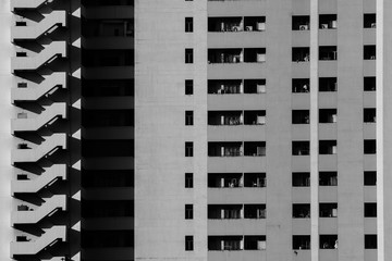 Fire escape and pattern of balcony at concrete building - monochrome